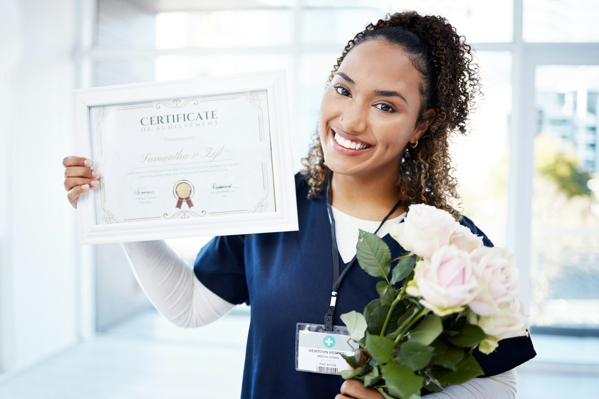 Certificate, rose and portrait with a black woman graduate in the hospital, proud of her achievemen